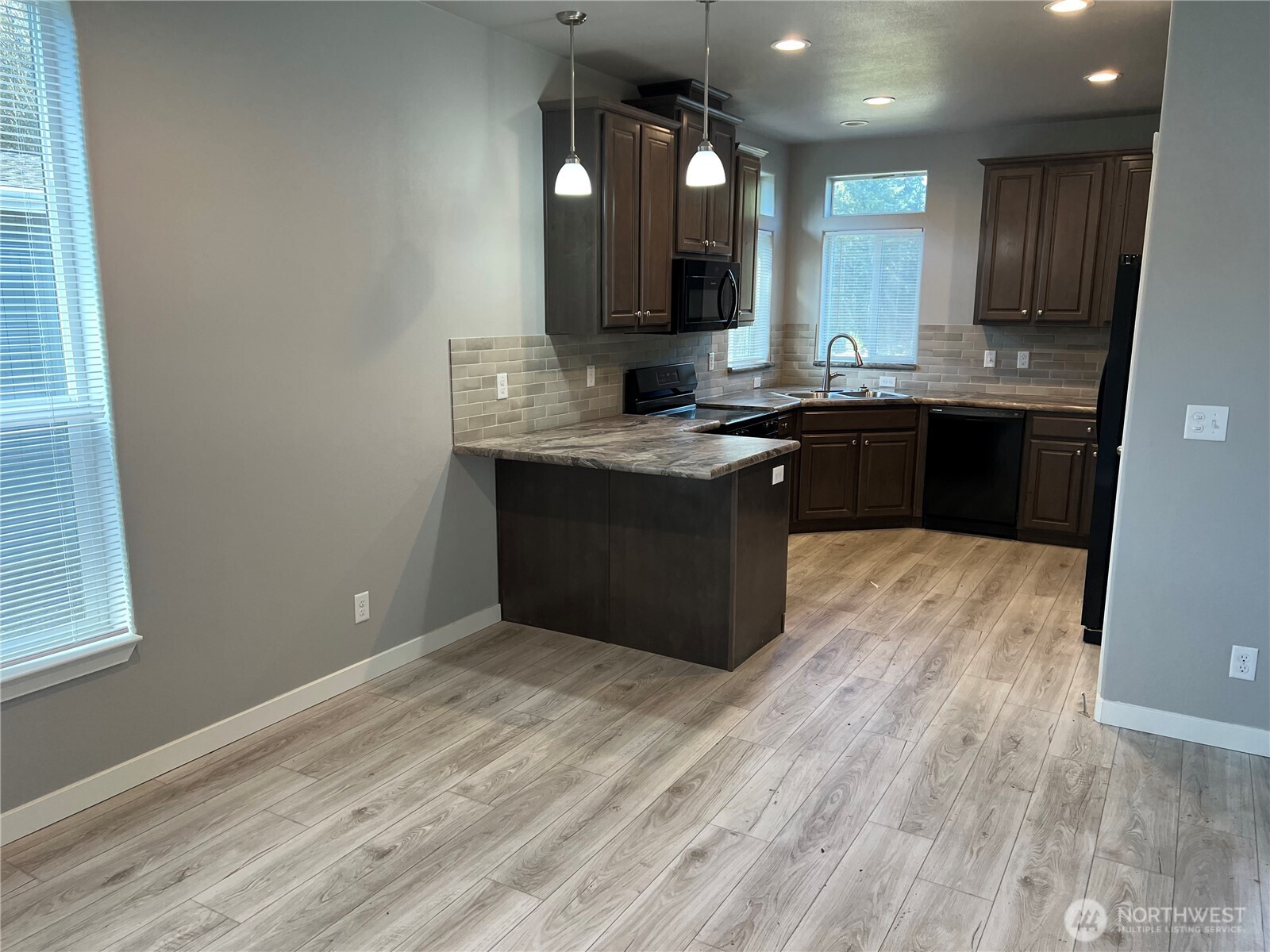 3371 Southeast Bielmeier Road, Unit 79 Port Orchard, WA 98367 - Photo 2 of 16 a kitchen with a sink cabinets and wooden floor