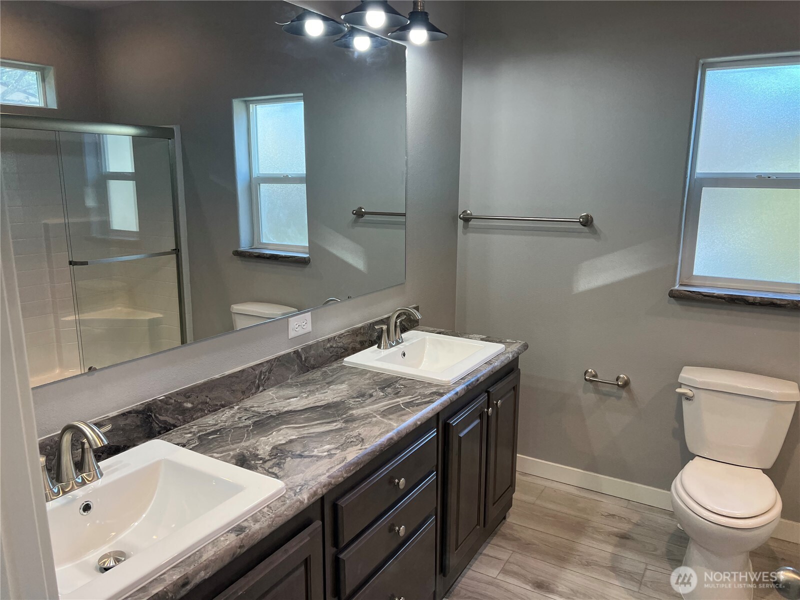 3371 Southeast Bielmeier Road, Unit 79 Port Orchard, WA 98367 - Photo 10 of 16 a bathroom with a granite countertop sink a toilet and a mirror