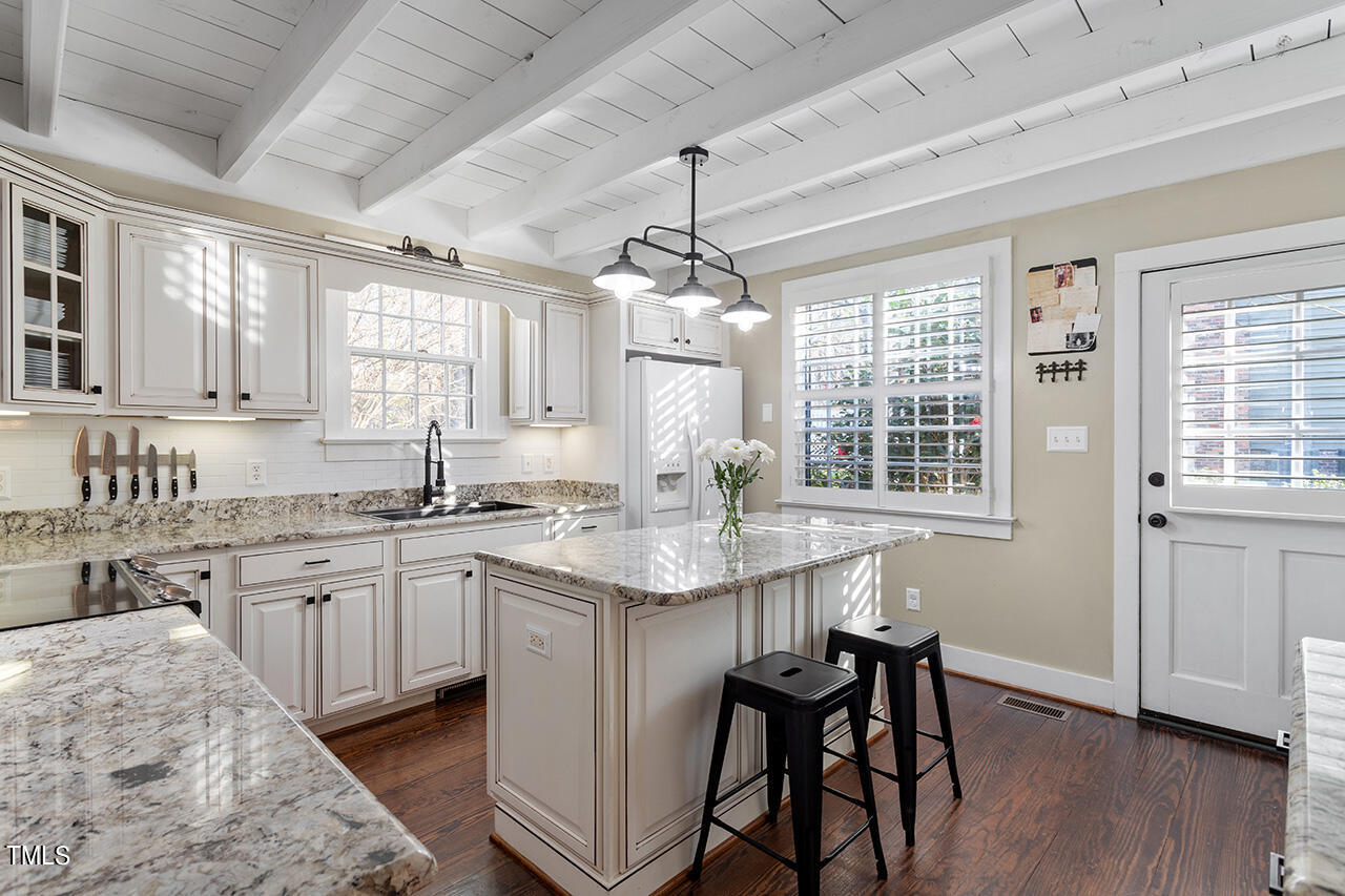 8301 Castine Court Raleigh, NC 27613 - Photo 10 of 38 a kitchen with center island table and chairs in it
