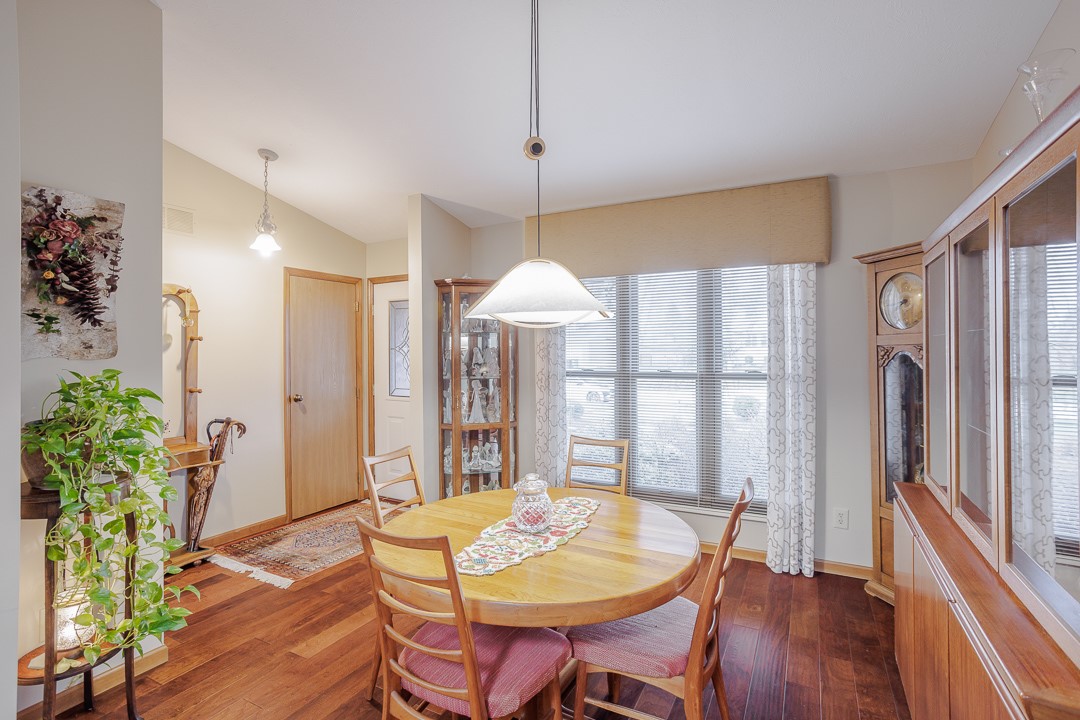 540 Basil Street Springboro, OH 45066 - Photo 4 of 32 Warm hardwood flooring and ample natural light define this inviting dining space.