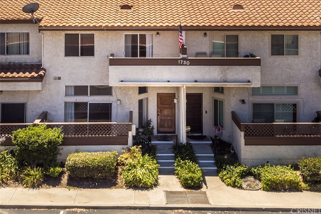 1730 Sinaloa Road, Unit 307 Simi Valley, CA 93065 - Photo 1 of 1 a front view of a house with a yard