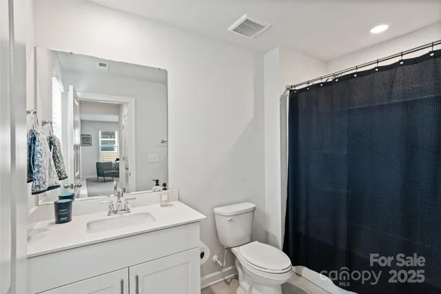 a bathroom with a sink toilet and mirror