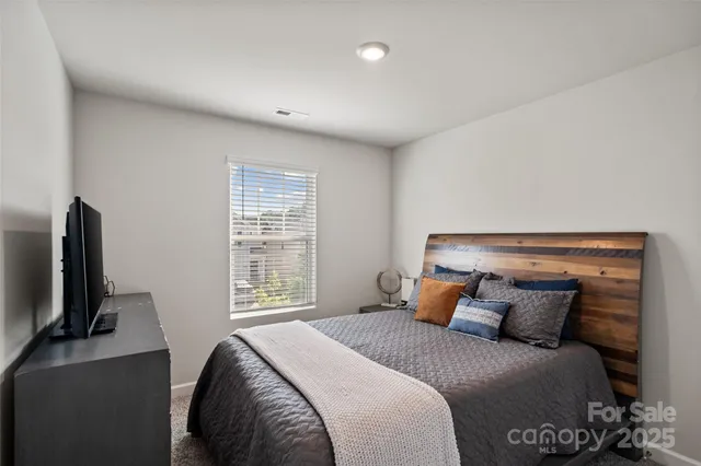 a bedroom with a bed and tv