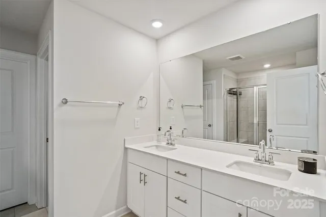 a bathroom with a double vanity sink mirror and double