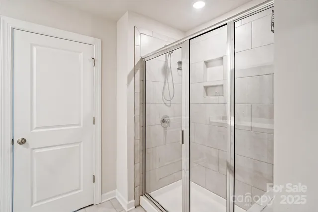 a bathroom with a glass shower door