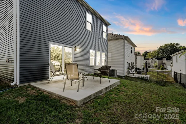 a view of a house with backyard and a sitting area