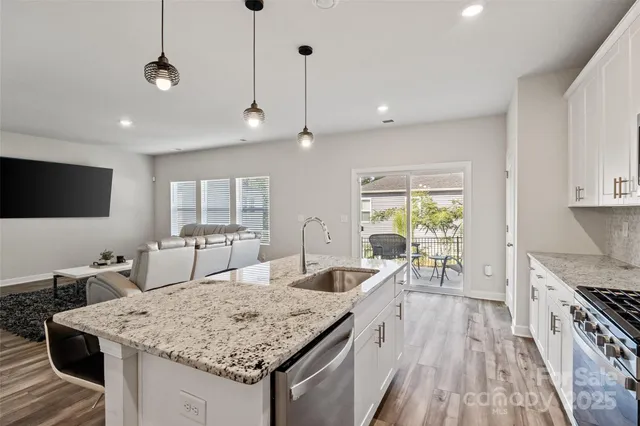 a kitchen with granite countertop a stove and a sink