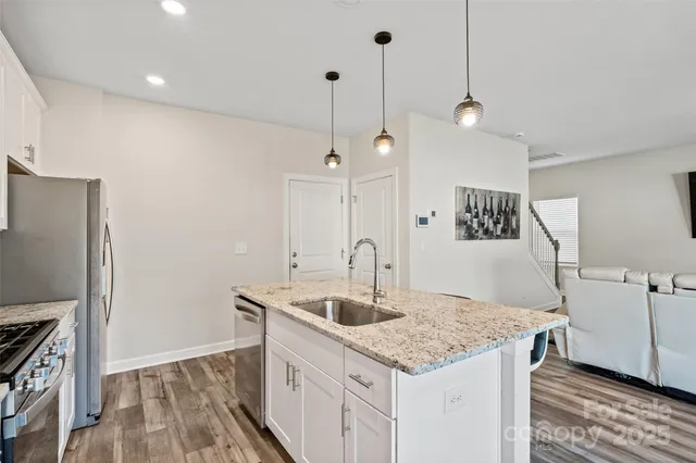 a kitchen with a sink a counter space and a refrigerator