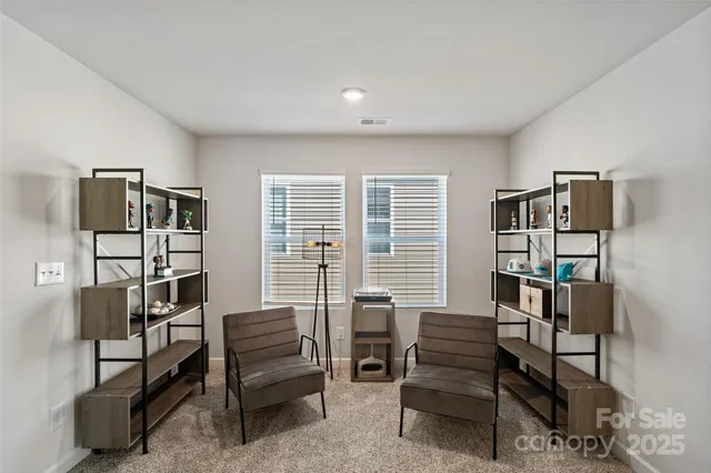 a view of a livingroom with furniture and a window