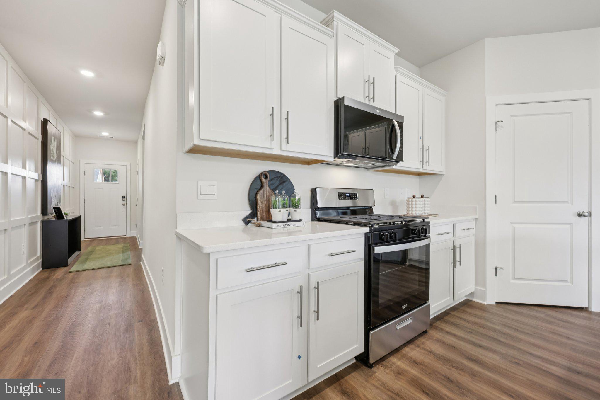 116 Trellis View Lane Winchester, VA 22602 - Photo 12 of 42 a kitchen with stainless steel appliances granite countertop a stove a sink and a microwave
