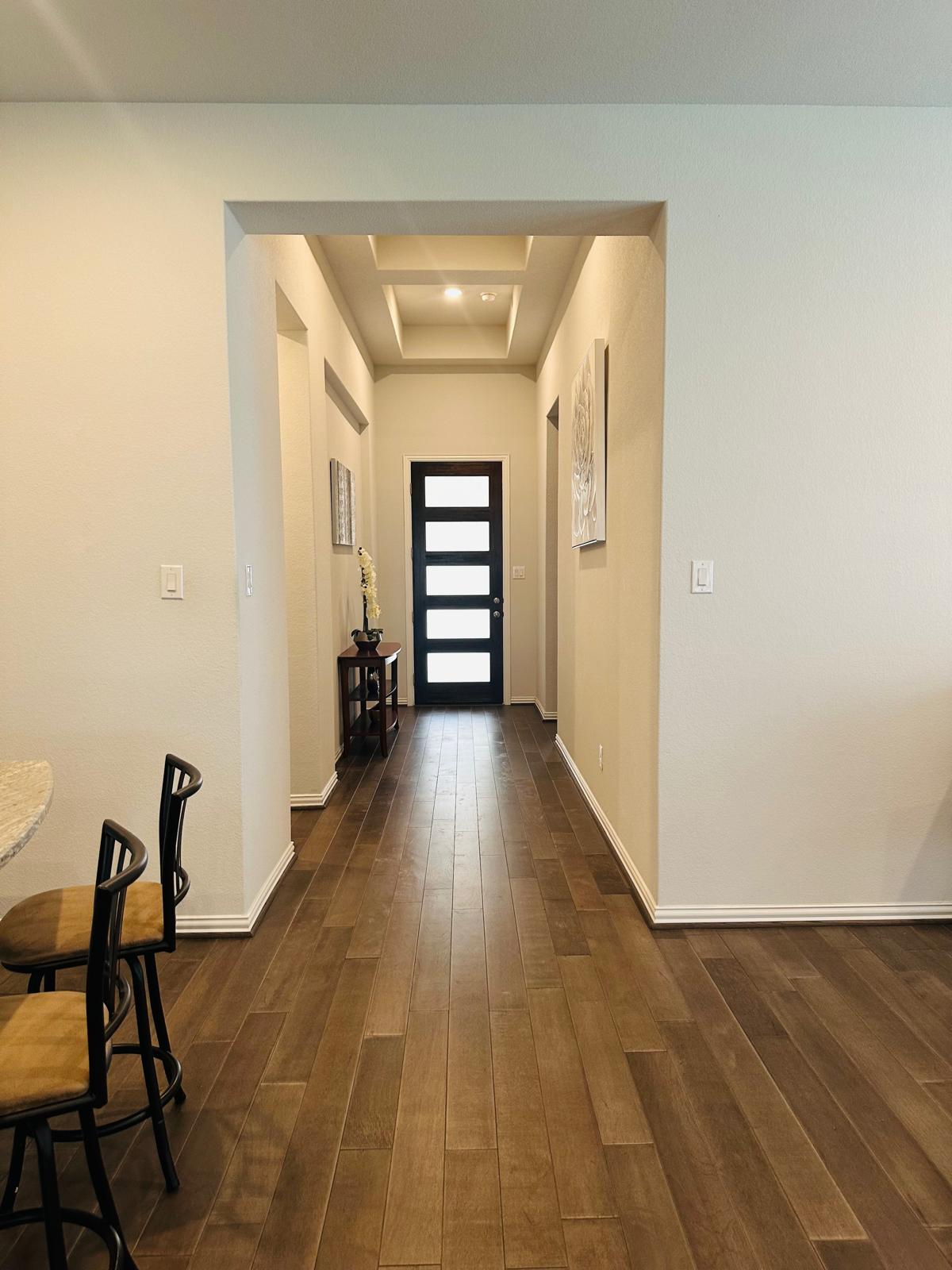 862 Leadtree Loop Buda, TX 78610 - Photo 5 of 40 a view of a hallway with wooden floor
