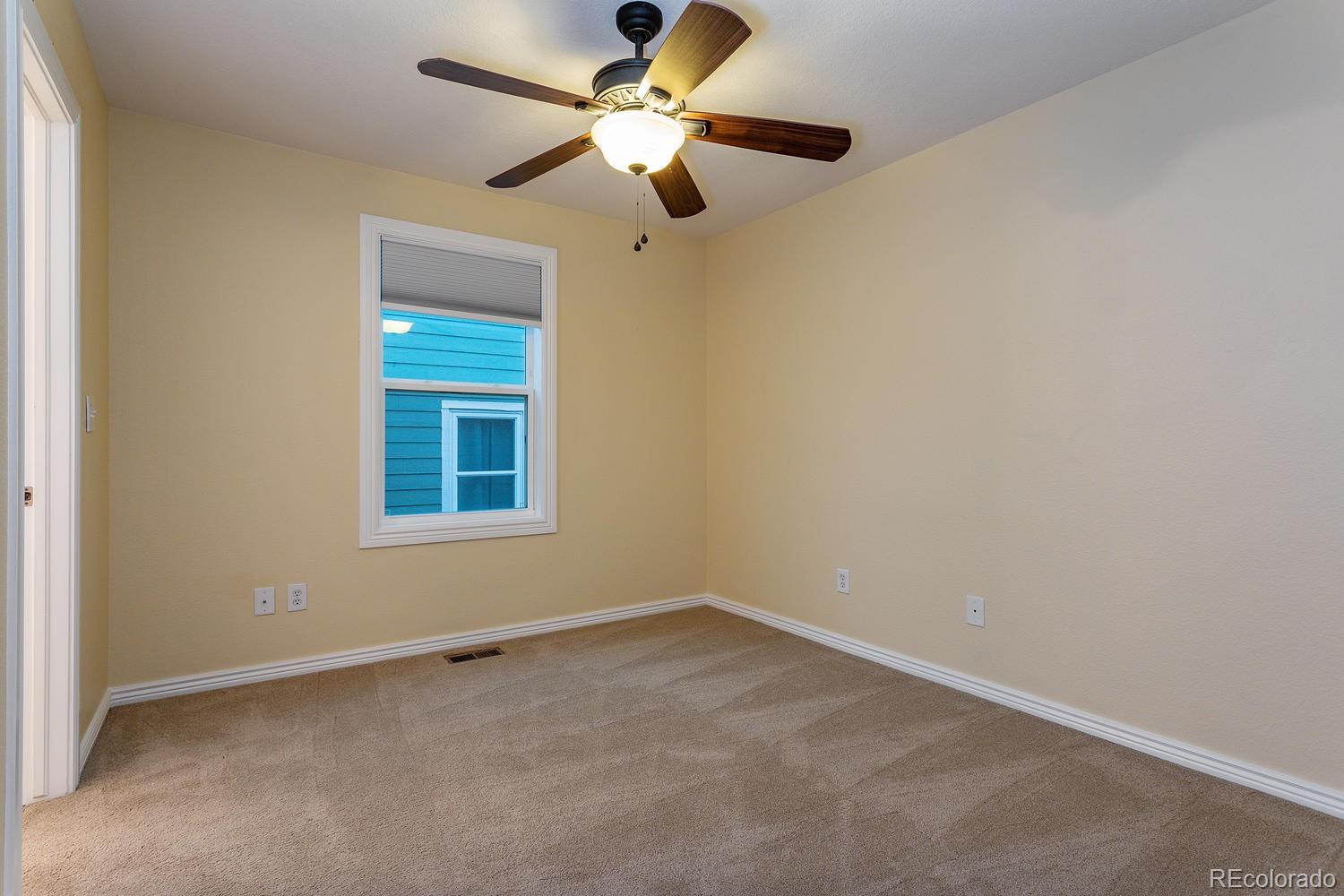 9869 Spring Hill Drive Highlands Ranch, CO 80129 - Photo 14 of 37 an empty room with a window and a fan