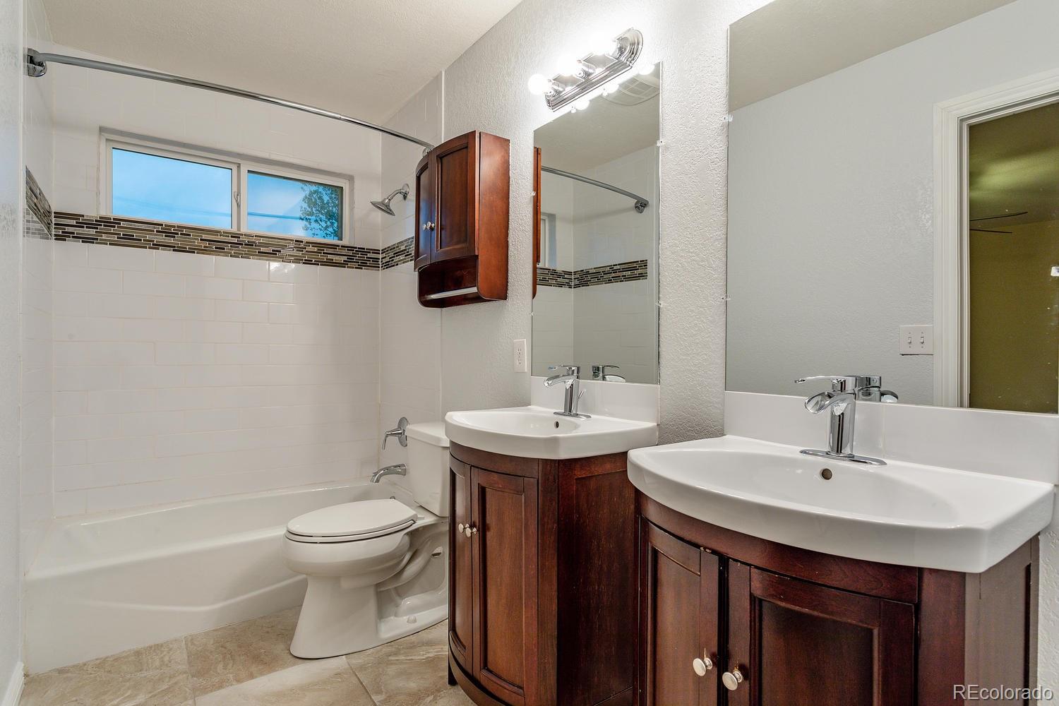 9869 Spring Hill Drive Highlands Ranch, CO 80129 - Photo 15 of 37 a bathroom with a sink toilet and a mirror