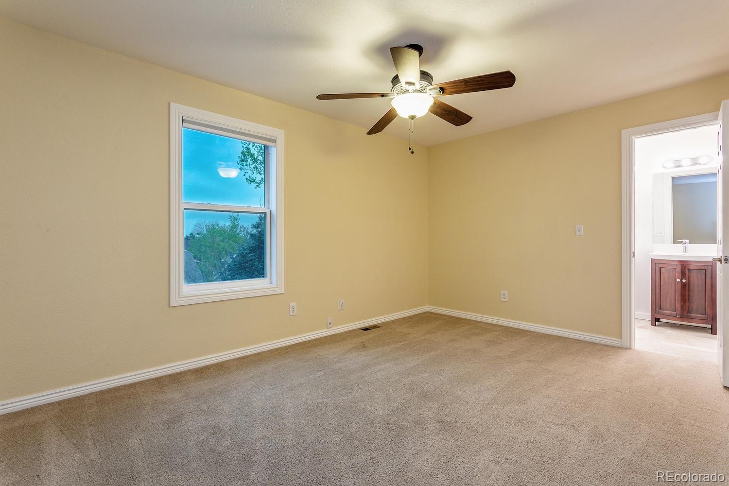 9869 Spring Hill Drive Highlands Ranch, CO 80129 - Photo 16 of 37 an empty room with windows and fan