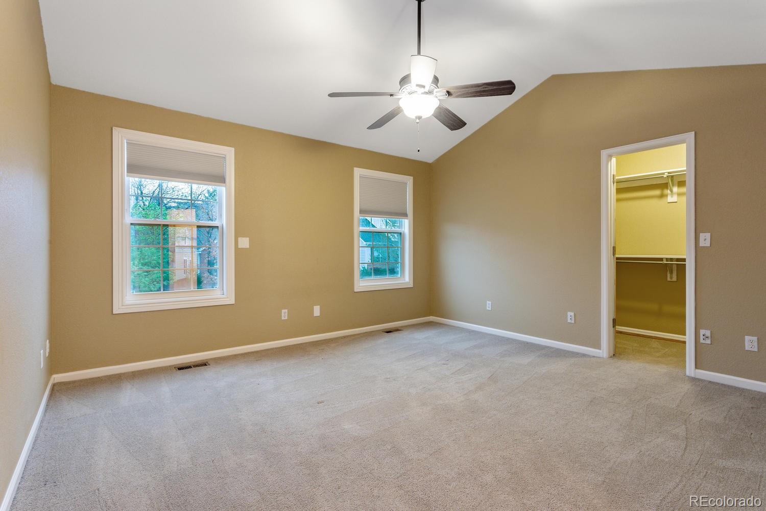9869 Spring Hill Drive Highlands Ranch, CO 80129 - Photo 18 of 37 an empty room with chandelier fan and windows
