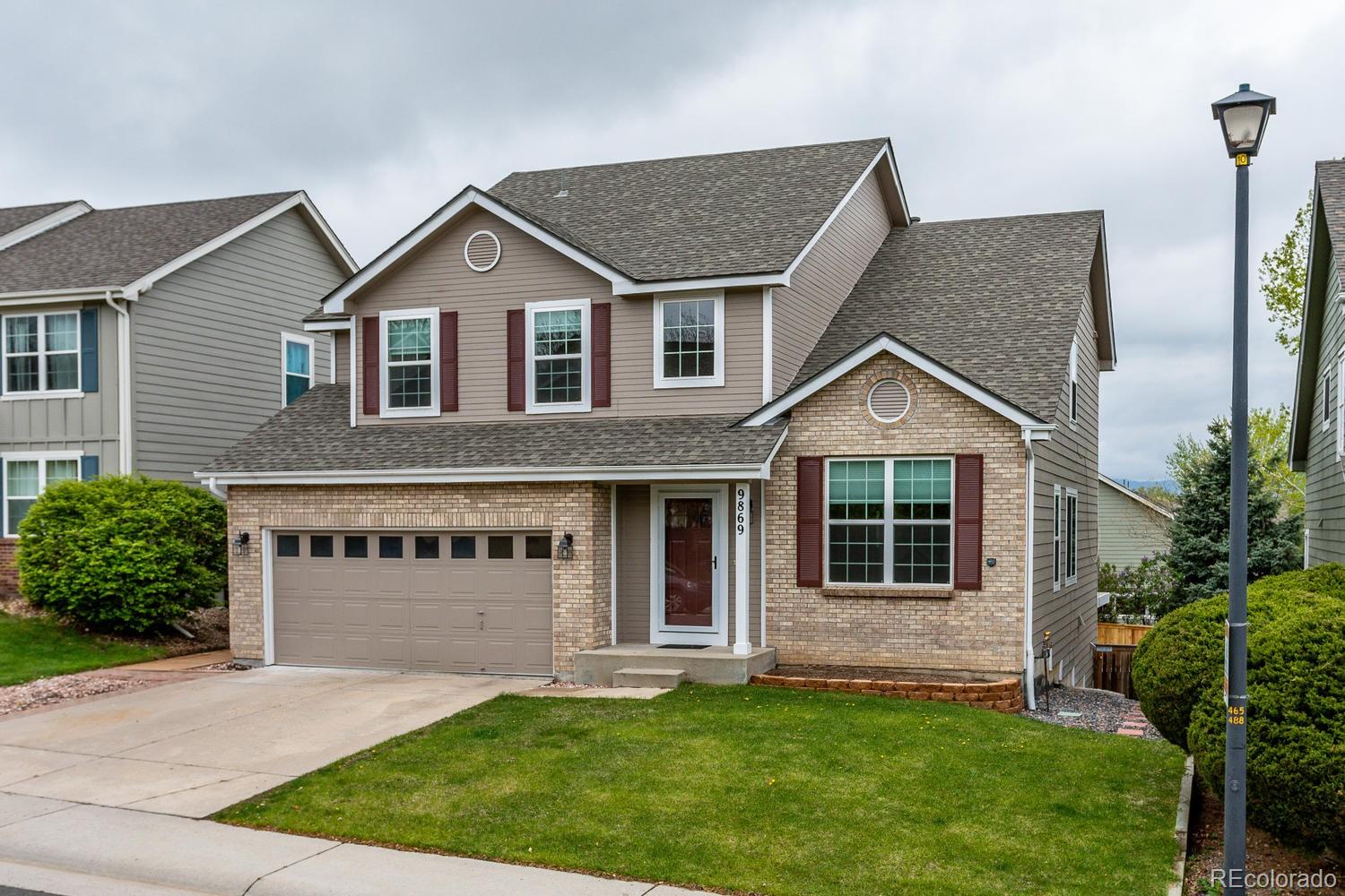 9869 Spring Hill Drive Highlands Ranch, CO 80129 - Photo 2 of 37 a view of house with yard and front view of a house