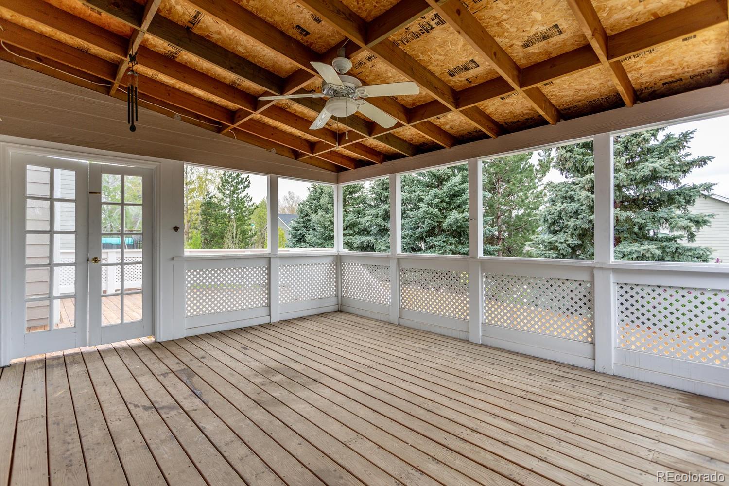 9869 Spring Hill Drive Highlands Ranch, CO 80129 - Photo 28 of 37 a view of an empty room with wooden floor and windows