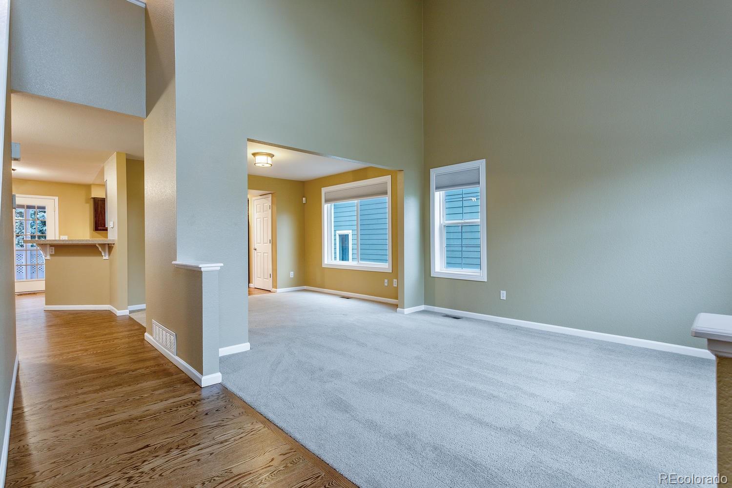 9869 Spring Hill Drive Highlands Ranch, CO 80129 - Photo 3 of 37 a view of an empty room with wooden floor and a window