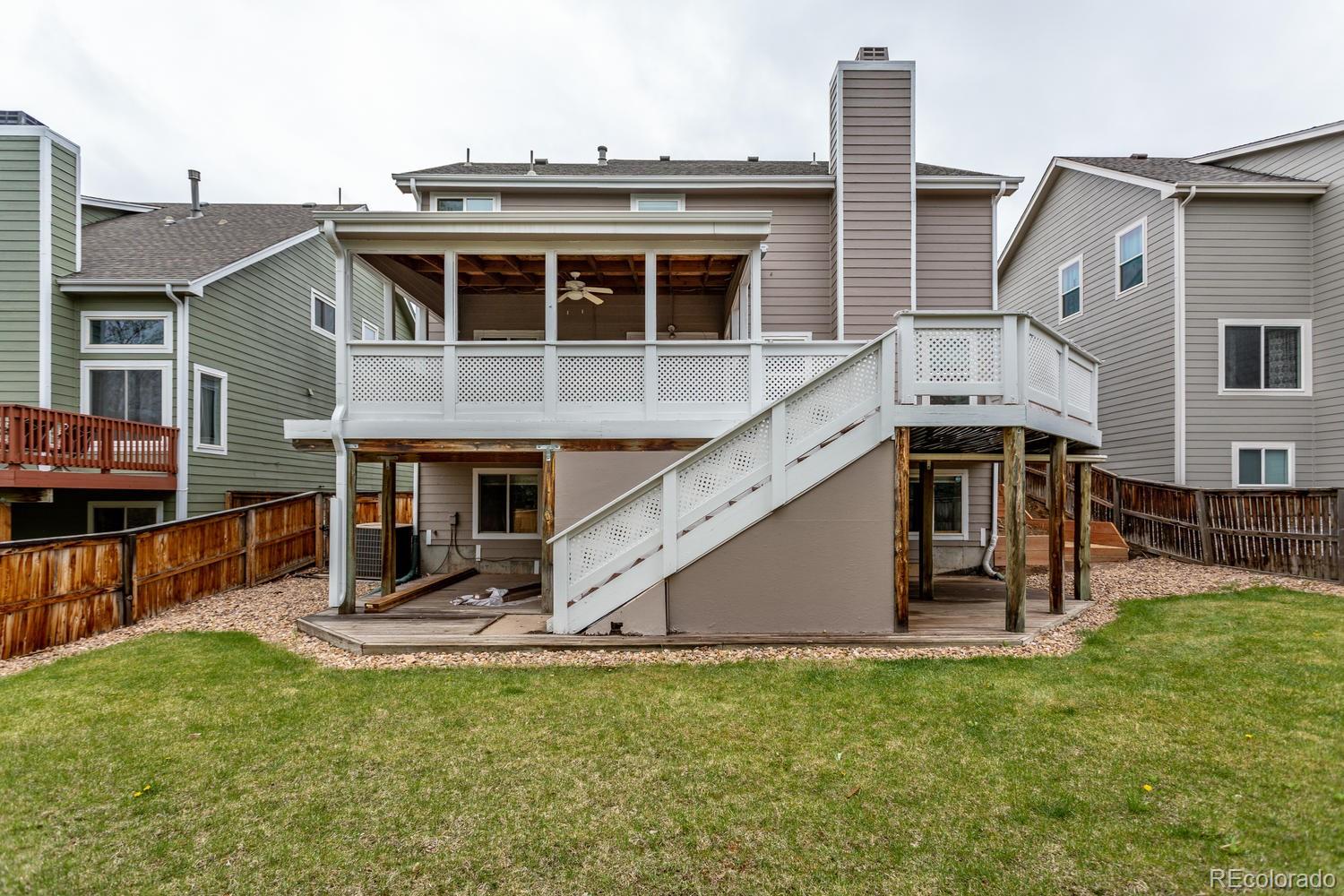 9869 Spring Hill Drive Highlands Ranch, CO 80129 - Photo 33 of 37 a view of a house with a yard and sitting area