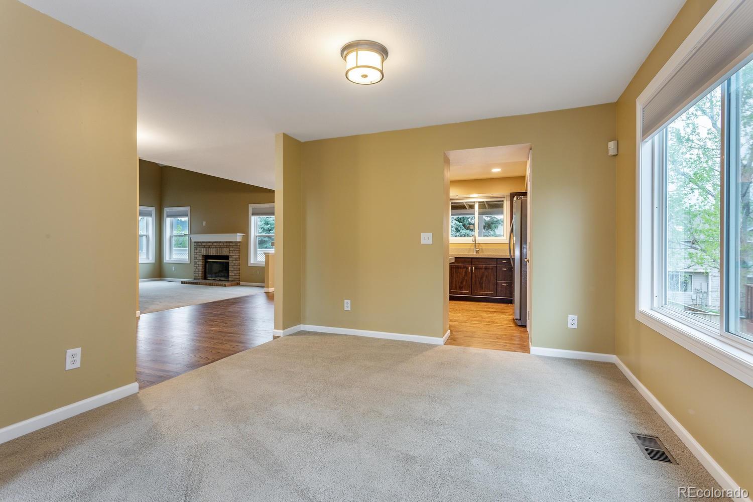 9869 Spring Hill Drive Highlands Ranch, CO 80129 - Photo 6 of 37 a view of a big room with windows and kitchen view