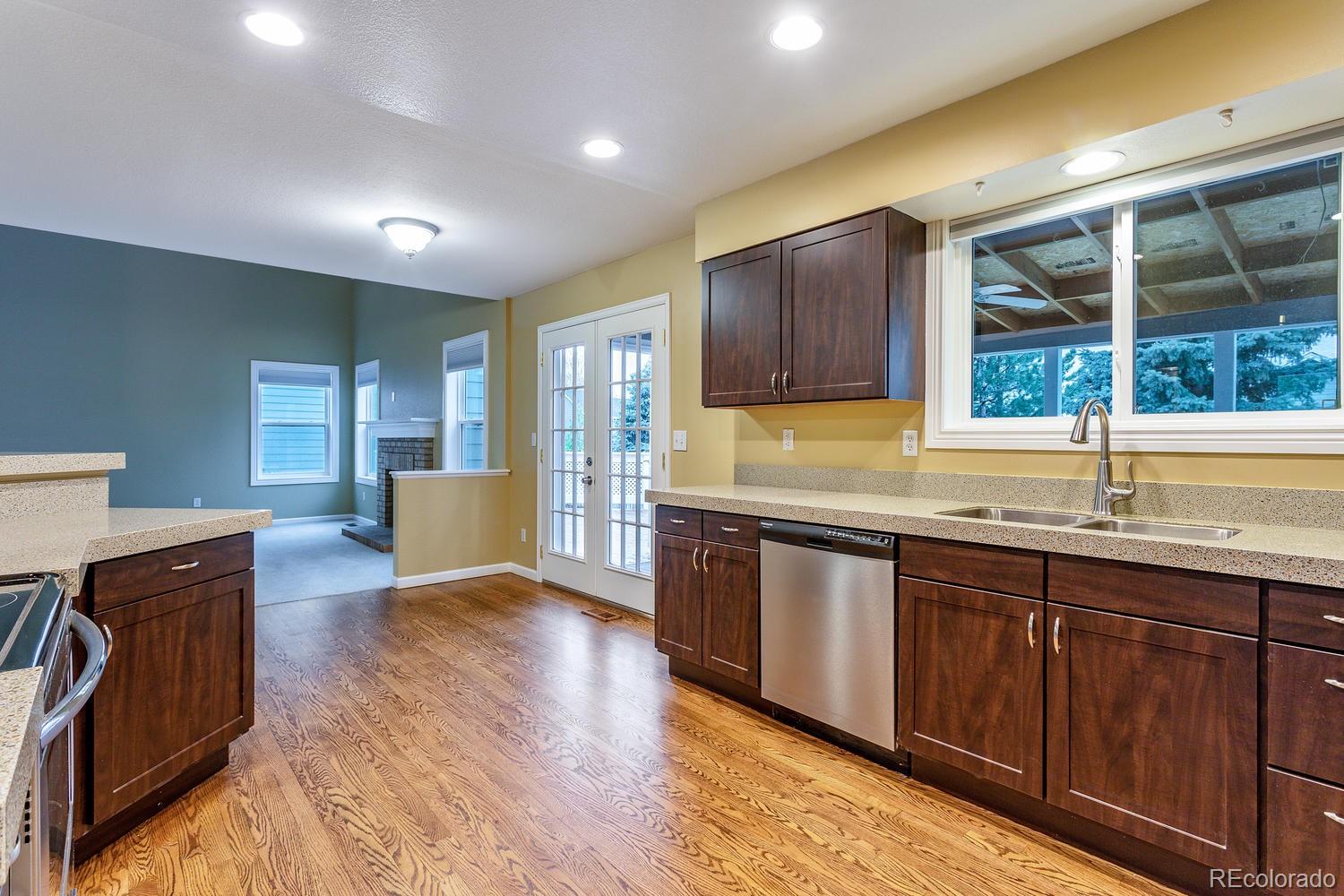 9869 Spring Hill Drive Highlands Ranch, CO 80129 - Photo 7 of 37 a kitchen with sink cabinets and wooden floor