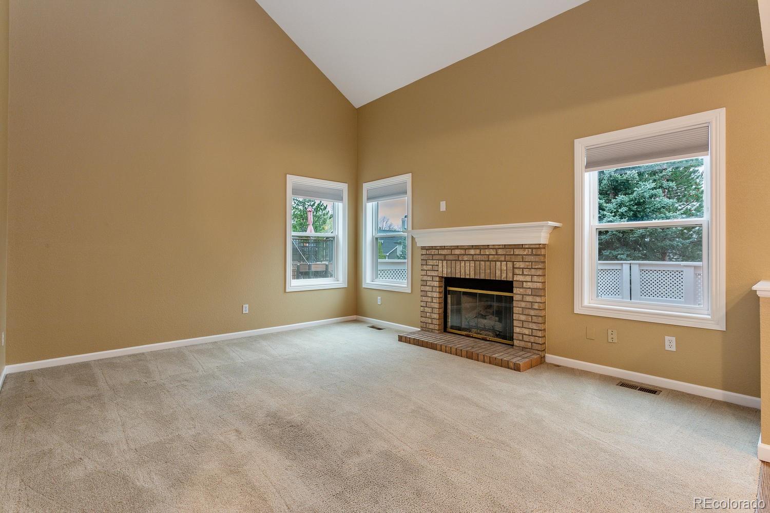 9869 Spring Hill Drive Highlands Ranch, CO 80129 - Photo 10 of 37 an empty room with a fireplace