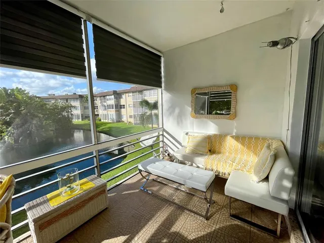 a balcony with chairs and a table
