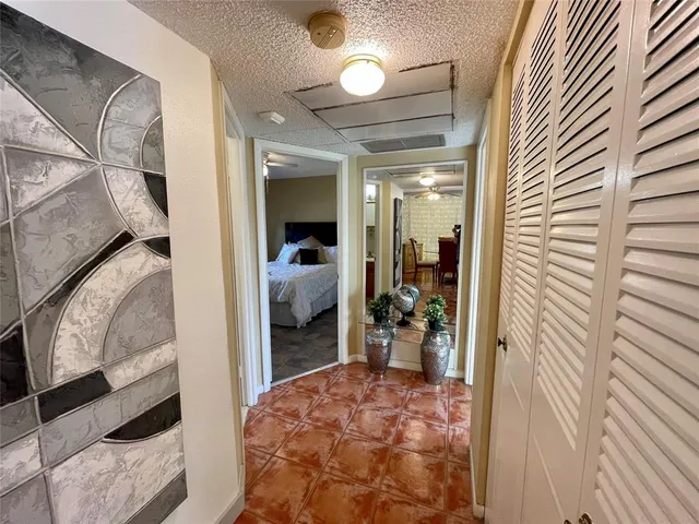 a view of a hallway and a livingroom with furniture