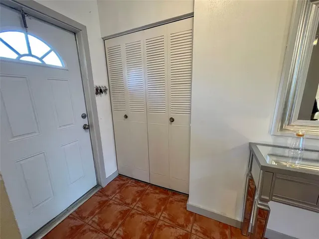 a view of hallway with a sink and a mirror