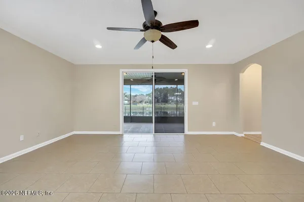 a spacious bedroom with a bed a couch and a window