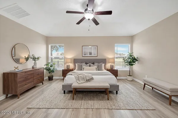 an empty room with closet and windows