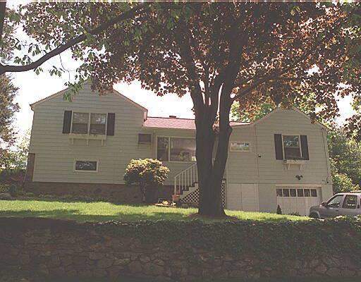 1 Hollow Spring Road Norwalk, CT 06854 - Photo 1 of 1 a front view of a house with a yard and garage