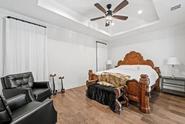 a bedroom with a bed and a chandelier