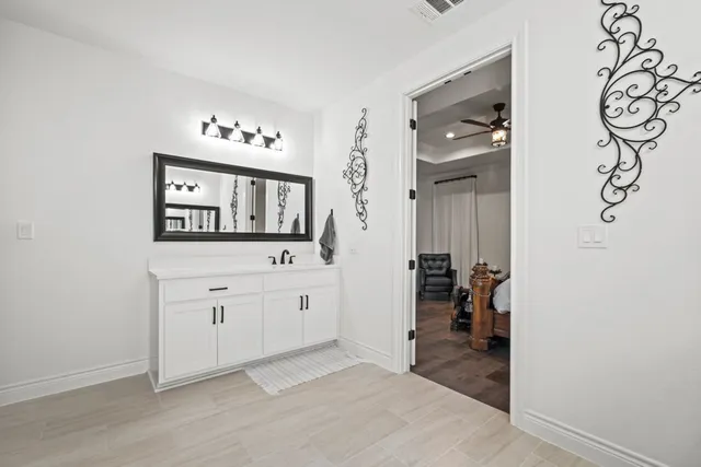 wooden floor with white cabinets