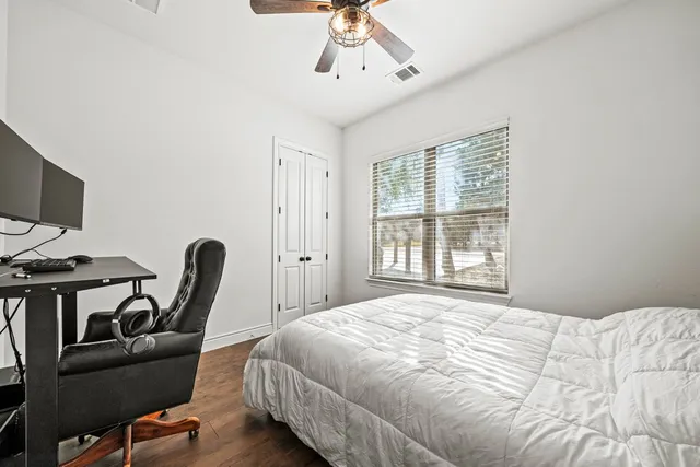 a bedroom with furniture and a window