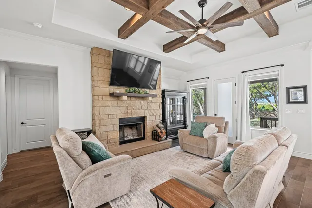 a living room with furniture fireplace and a flat screen tv