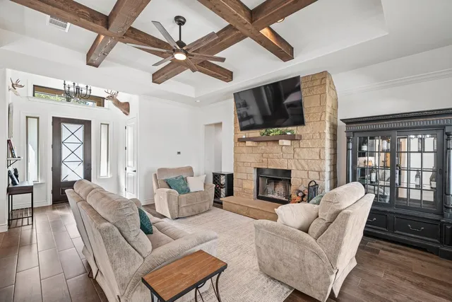 a living room with furniture fireplace and a flat screen tv