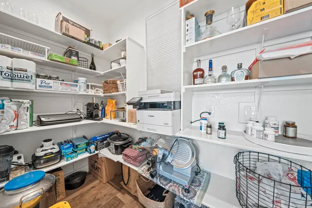 a room with furniture a rug toys and wooden floor