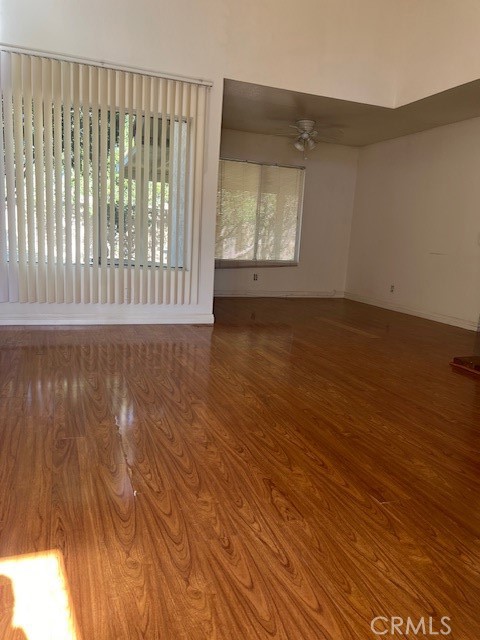 1148 West Cornell Street Rialto, CA 92376 - Photo 3 of 21 an empty room with wooden floor and windows