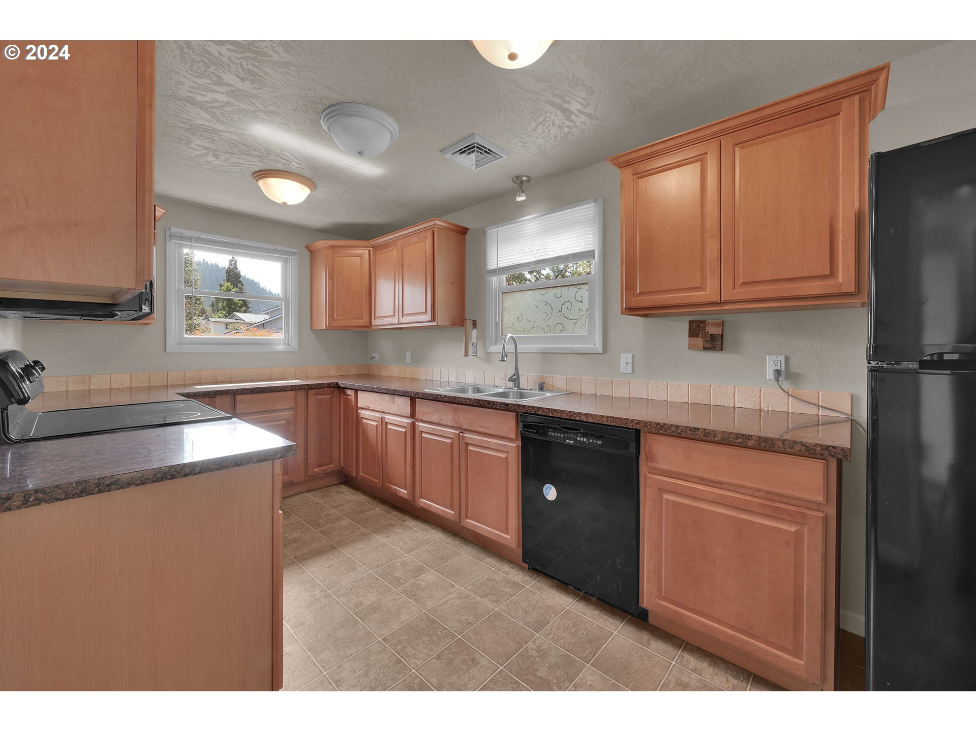 750 66th Street Springfield, OR 97478 - Photo 15 of 41 a kitchen with stainless steel appliances granite countertop a sink stove and refrigerator