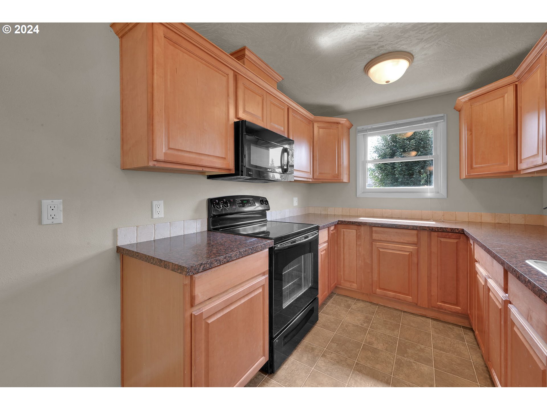 750 66th Street Springfield, OR 97478 - Photo 17 of 41 a kitchen with stainless steel appliances granite countertop a sink stove and microwave