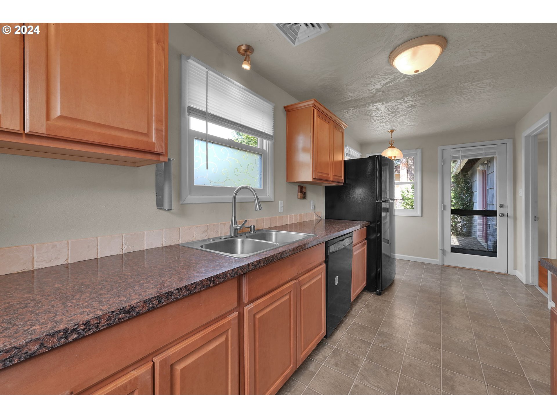 750 66th Street Springfield, OR 97478 - Photo 18 of 41 a kitchen with granite countertop a sink a counter space appliances and cabinets