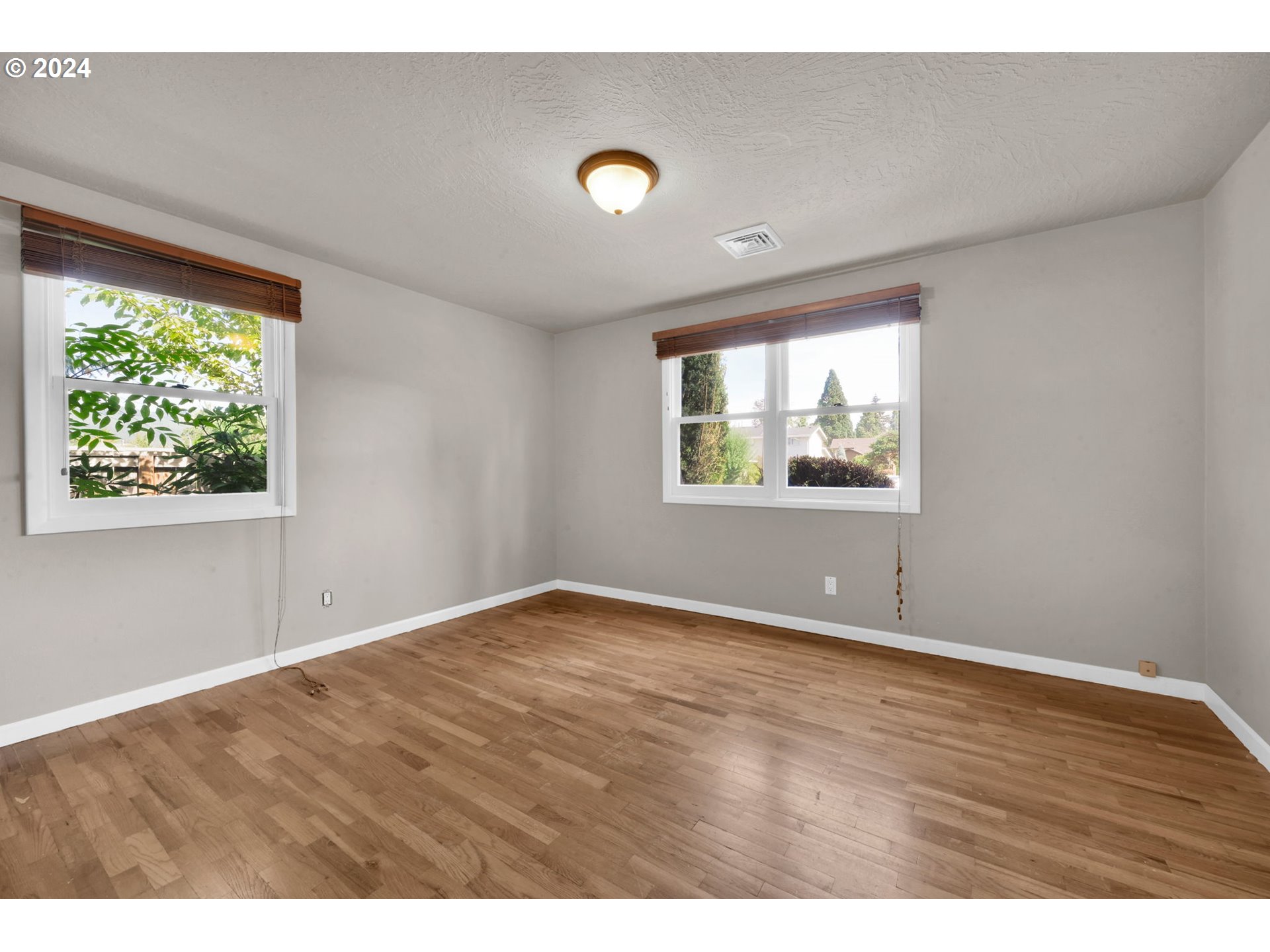 750 66th Street Springfield, OR 97478 - Photo 23 of 41 a view of an empty room with wooden floor and a window
