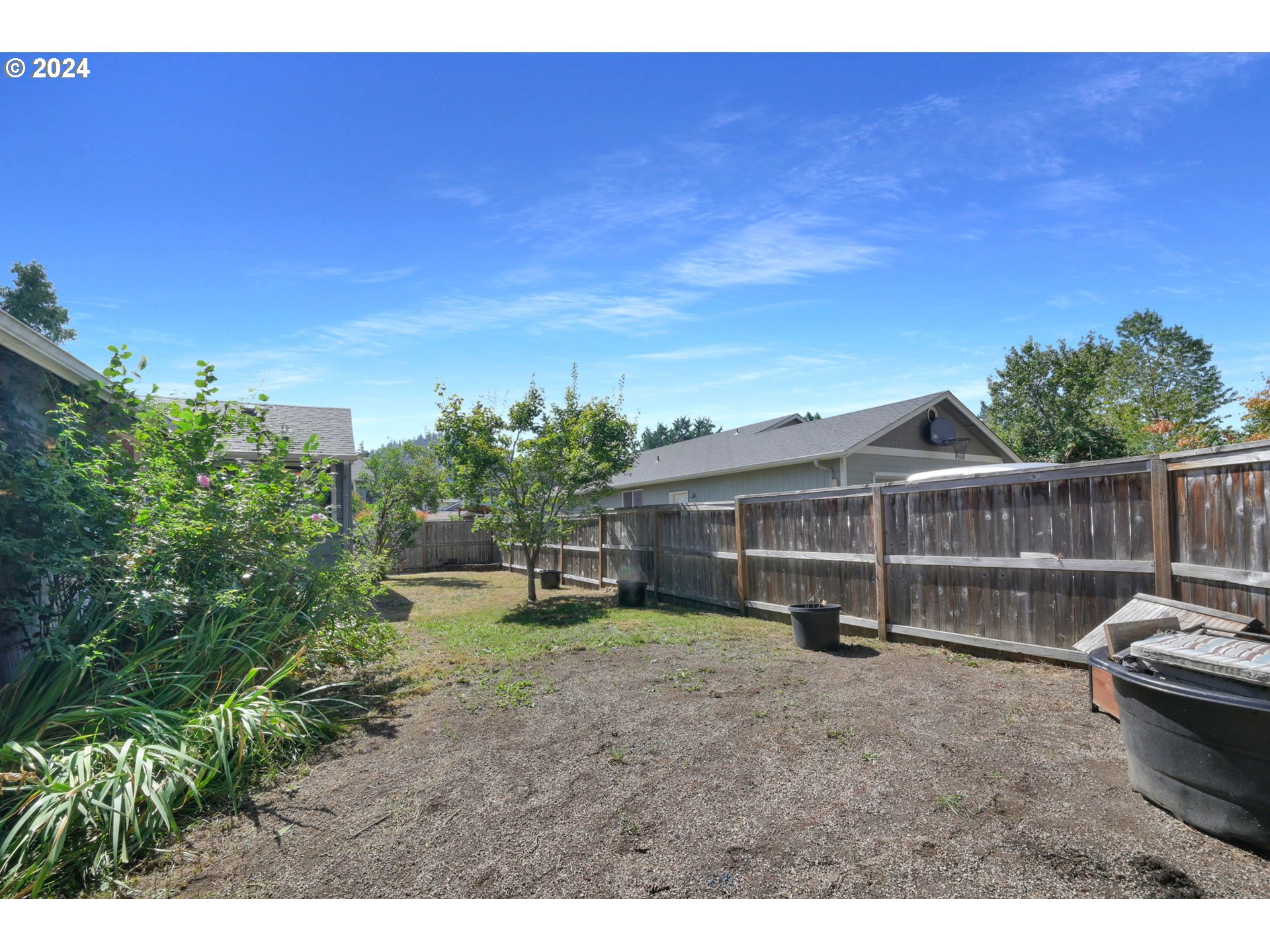 750 66th Street Springfield, OR 97478 - Photo 38 of 41 a view of a backyard with couches and wooden fence