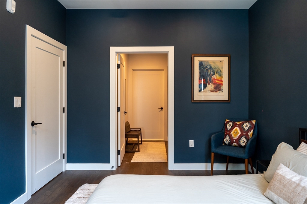 2 Sinclair Road, Unit 202 Boston, MA 02134 - Photo 11 of 23 a bedroom with a bed and a painting on the wall
