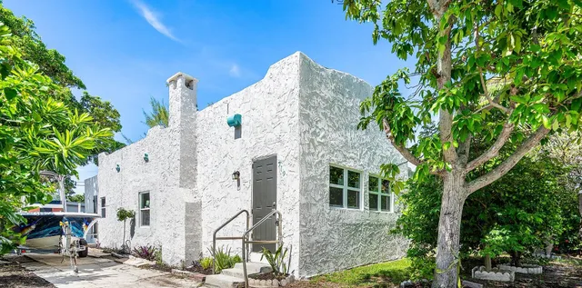 front view of a house with a tree