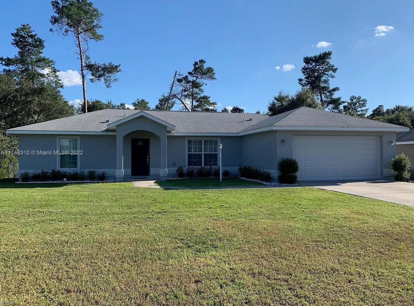 3140 Southwest 133rd Ln Road Ocala, FL 34473 - Photo 1 of 1 a front view of a house with a garden