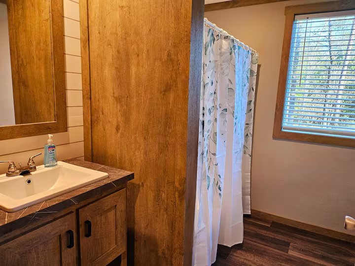 105 Saddle Surrey Road Coldspring, TX 77331 - Photo 33 of 48 a bathroom with a sink and a mirror