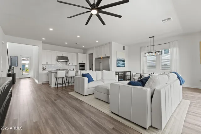 a living room with furniture and a wooden floor