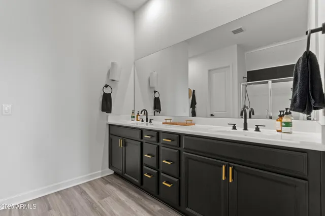 a bathroom with a double vanity sink and a mirror